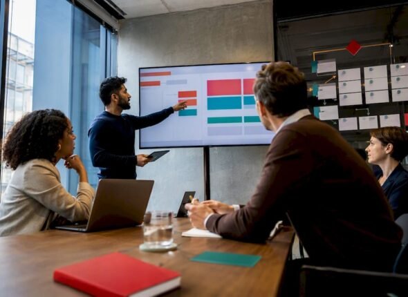 Practitioners reviewing hybrid delivery workflow