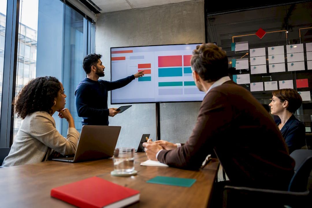 Practitioners reviewing hybrid delivery workflow