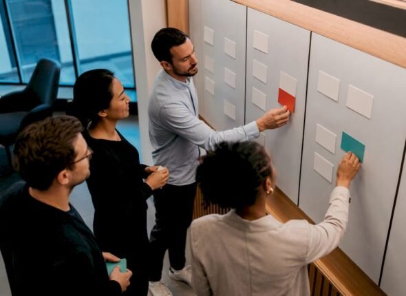 Professionals reviewing a Kanban workflow board